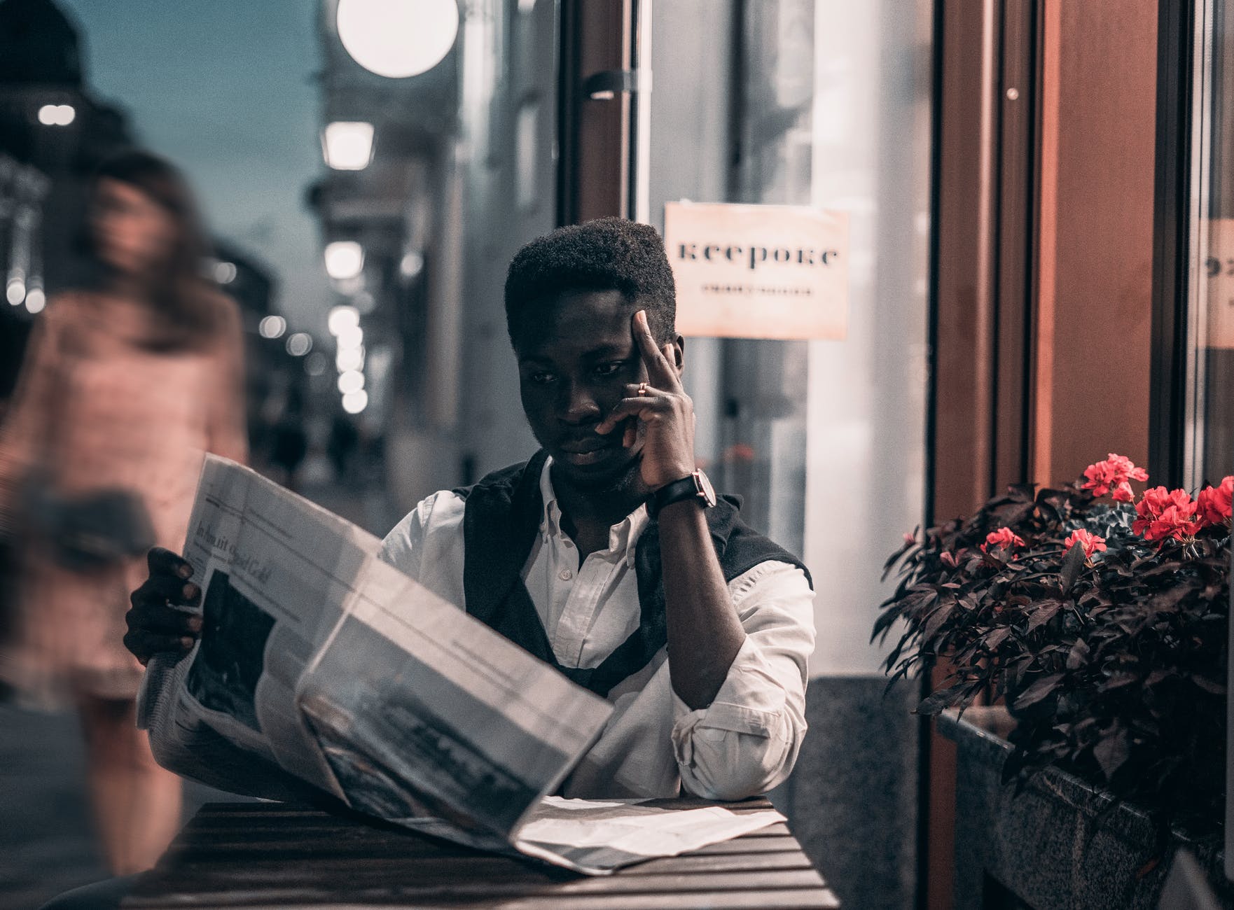 black man reading a newspaper